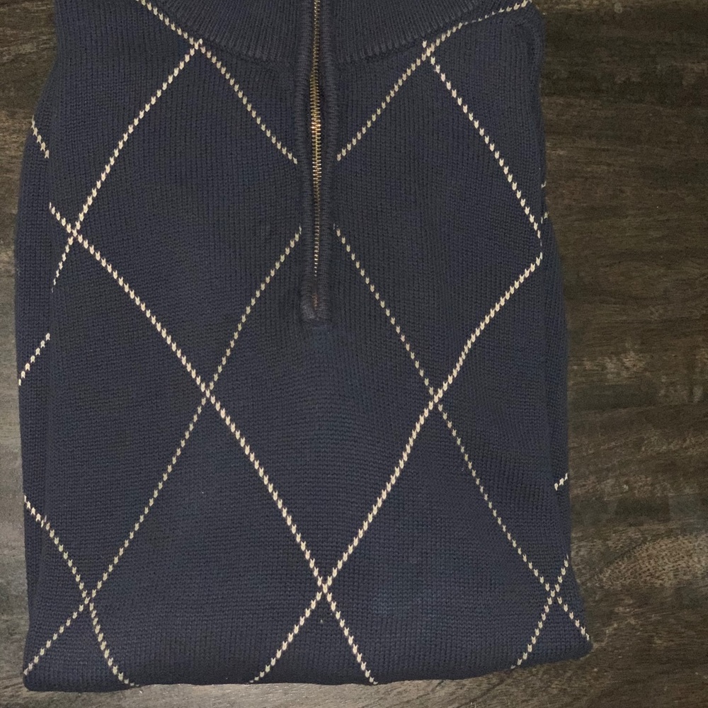 Navy blue and tan sweater. Zip up to the neck, 100% cotton. Dry clean preferred.